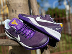 Purple Kobe 8 shoes displayed together with visible side Swooshes.