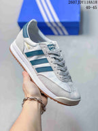 White adidas SL 72 sneaker with teal-blue stripes and a gum-colored outsole.