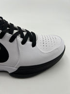 Close-up of the perforated toe, white upper, and black outsole