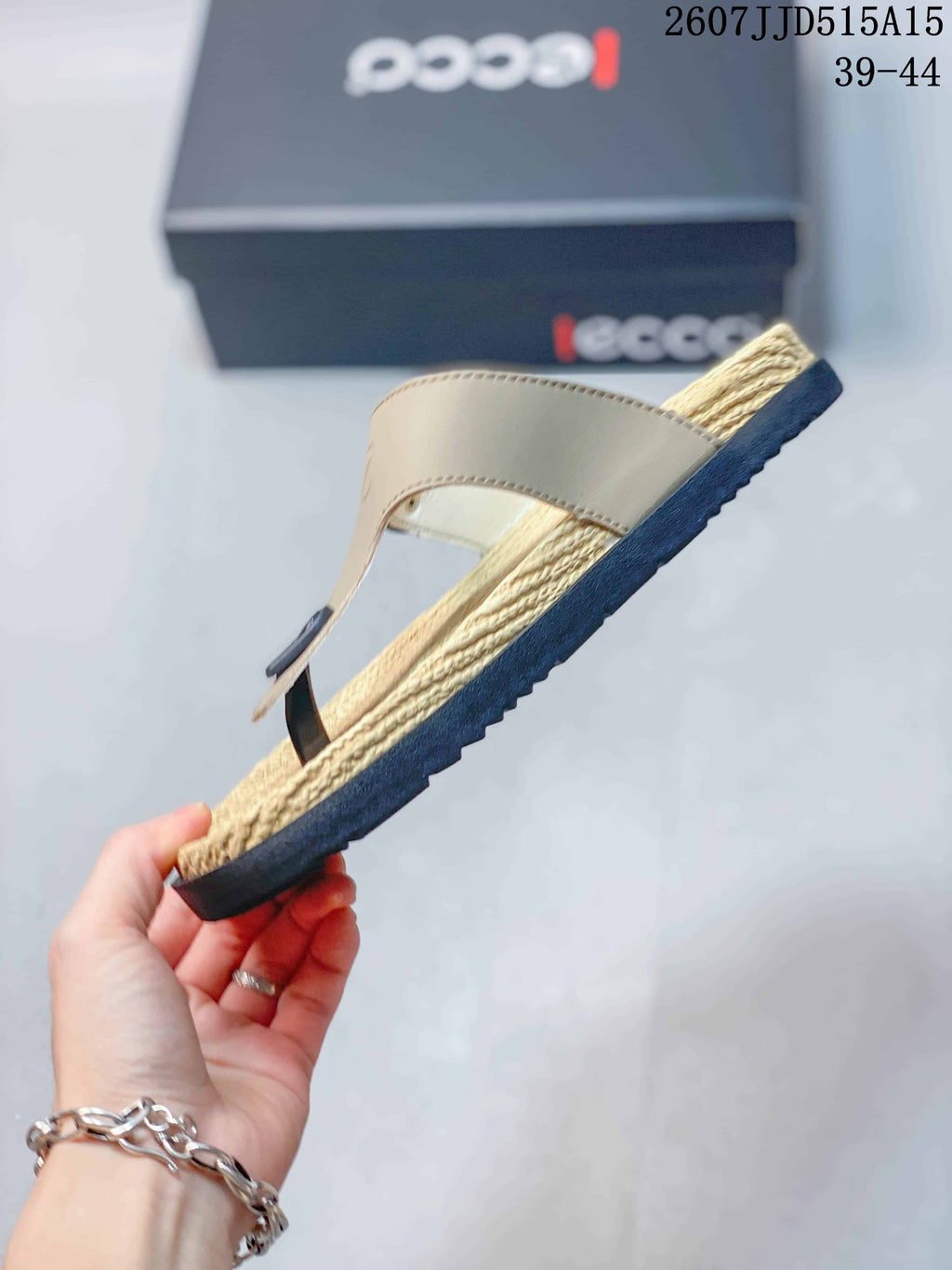 Side profile showing the beige upper, textured footbed, and contrasting black outsole.