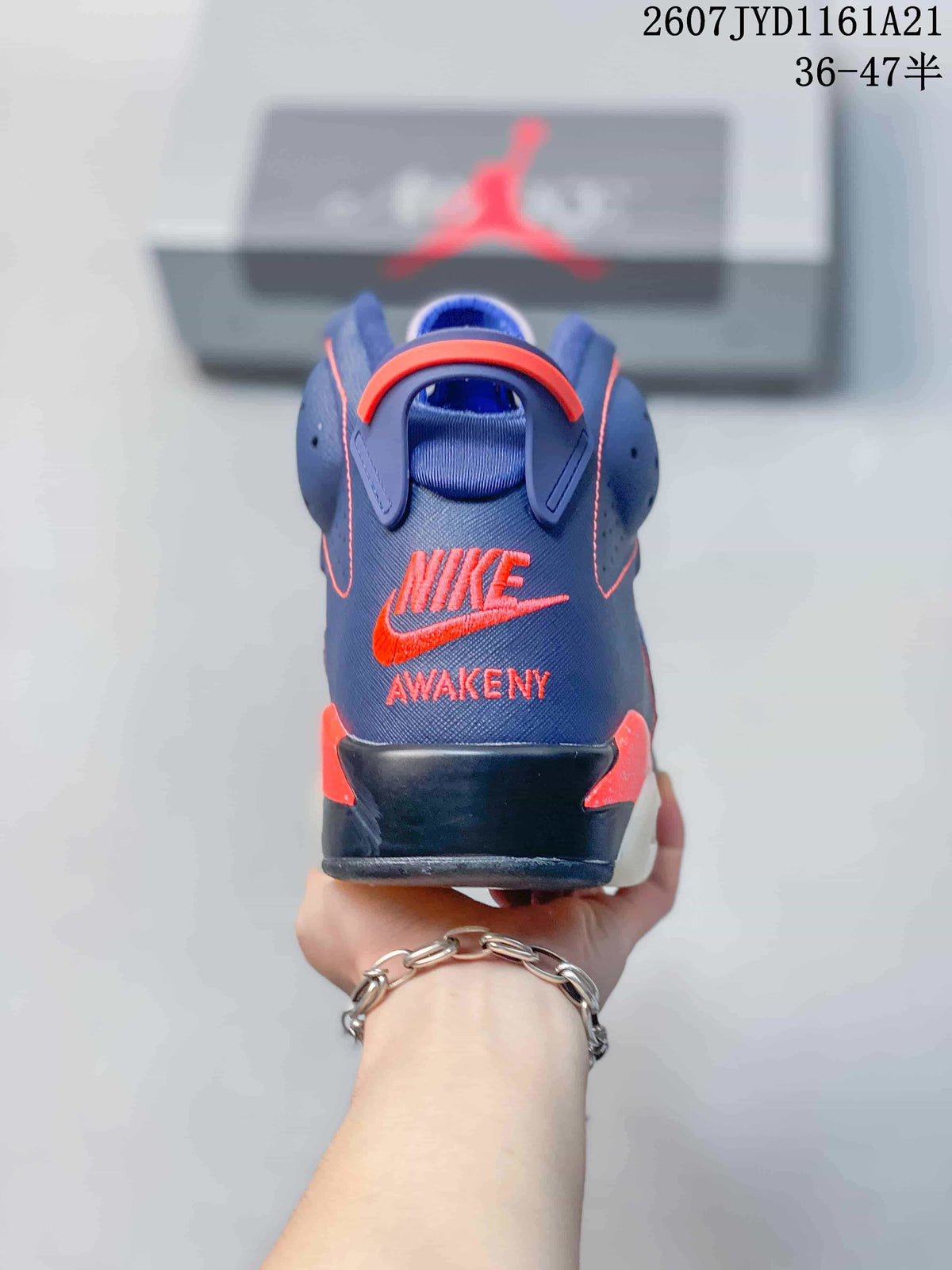 Rear view of the high-top sneaker showing red trim, heel structure, and Nike branding with the word Awakening.