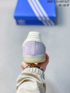Rear view showing the lavender heel panels, cream heel collar, and translucent rubber outsole.