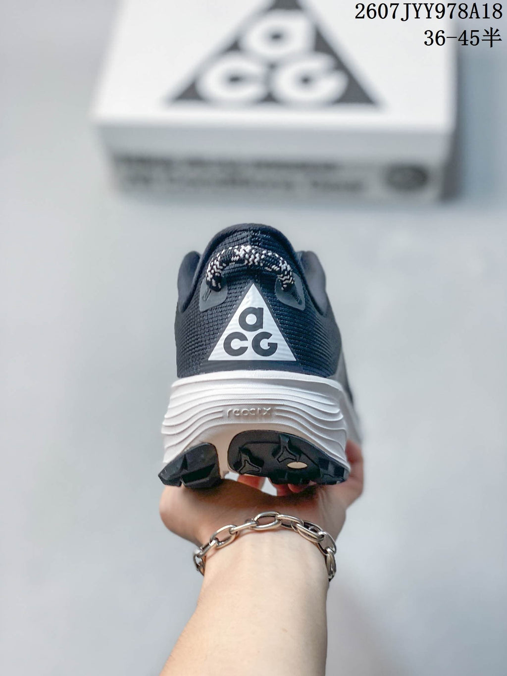 Rear view showing the ACG heel logo, padded collar, white midsole, and outsole tread.
