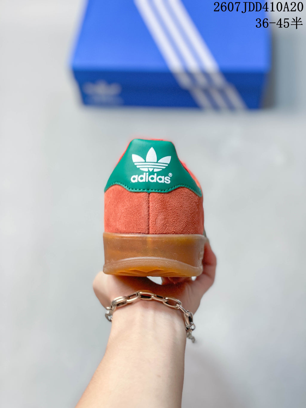 Rear view showing the coral heel, green heel tab, adidas branding and gum-colored sole.