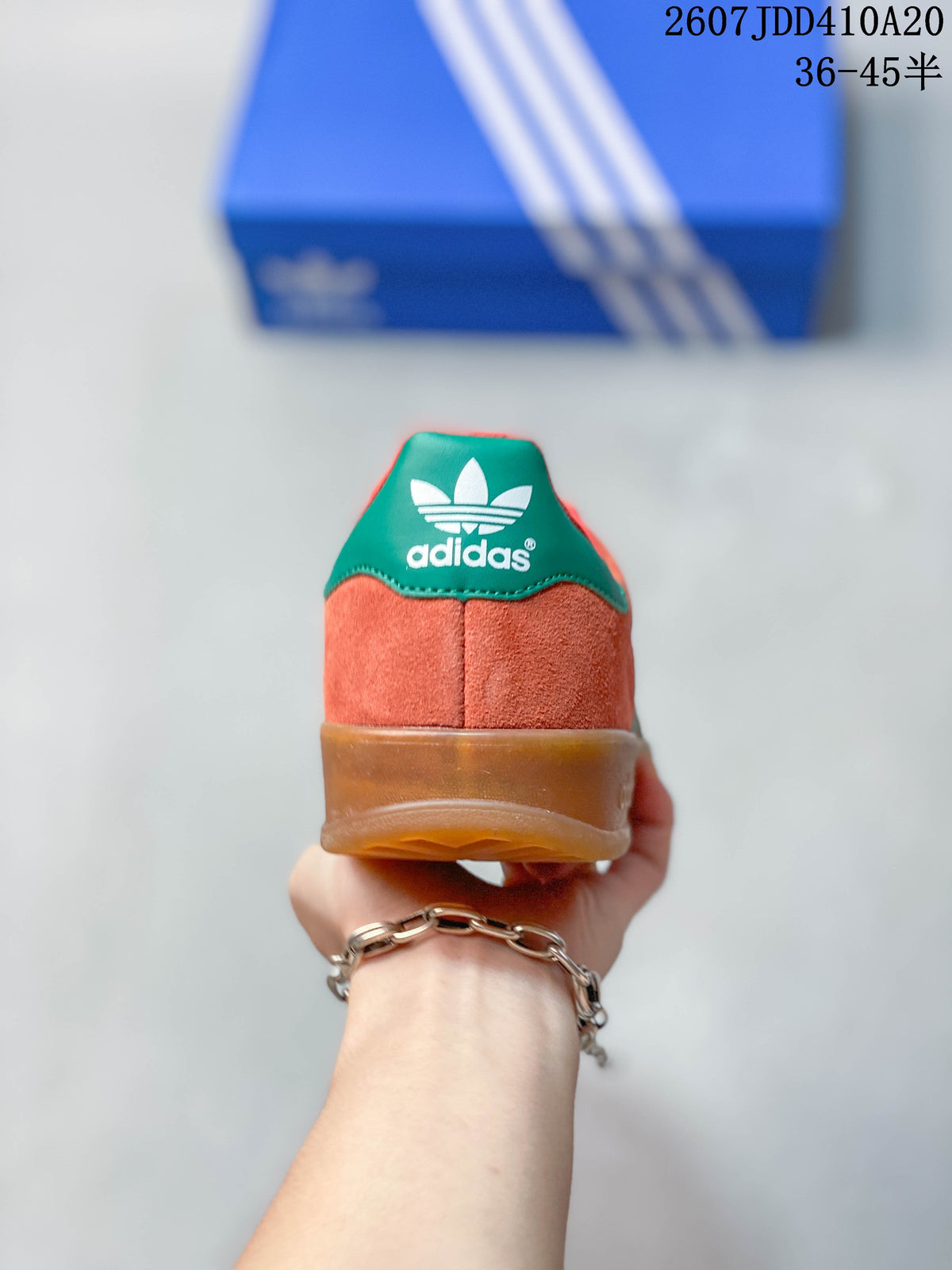 Rear view showing the coral heel, green heel tab, adidas branding and gum-colored sole.
