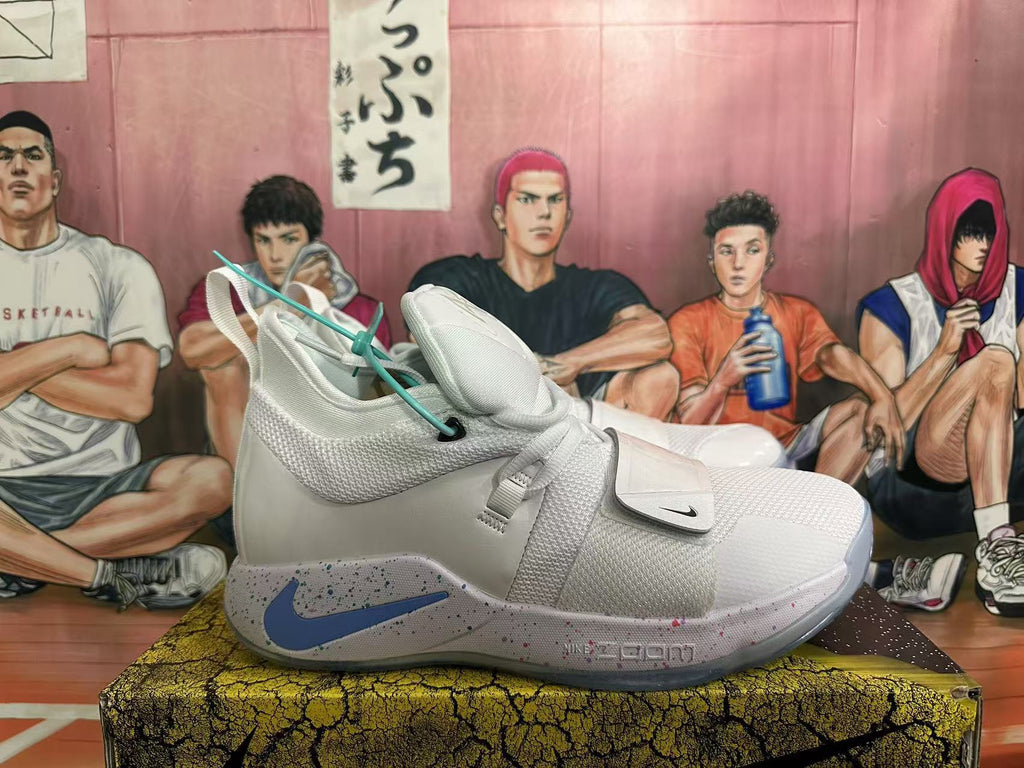 Side view of a white Nike PG 6 basketball shoe with a blue Swoosh and multicolor-speckled midsole.