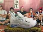 Side view of a white Nike PG 6 basketball shoe with a blue Swoosh and multicolor-speckled midsole.