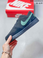 Side profile of the black low-top sneaker showing the mint-green side logo, stitched panels, and flat rubber sole.