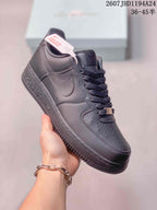 Angled view of a black Nike Air Force 1 '07 sneaker showing the tonal Swoosh, perforated toe panel and padded collar.
