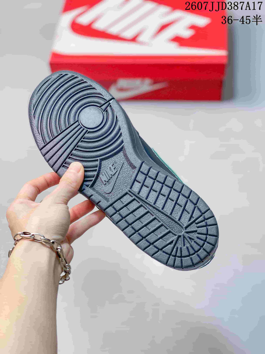 Close-up of the black textured outsole showing circular and grid-pattern tread.