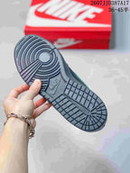 Close-up of the black textured outsole showing circular and grid-pattern tread.