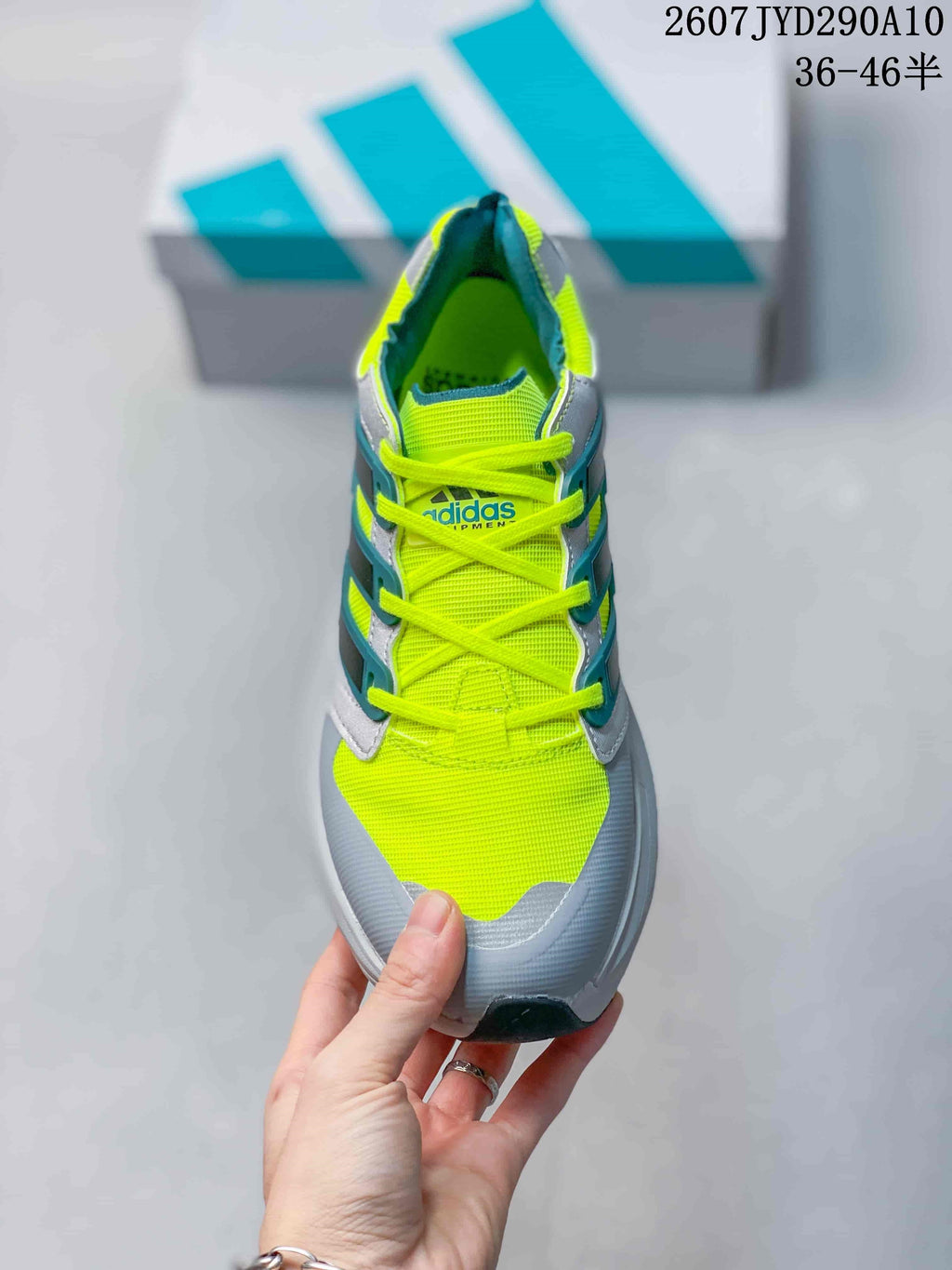 Top view of the adidas Equipment Adios Pro shoe showing neon yellow laces and upper, grey overlays and teal side accents.
