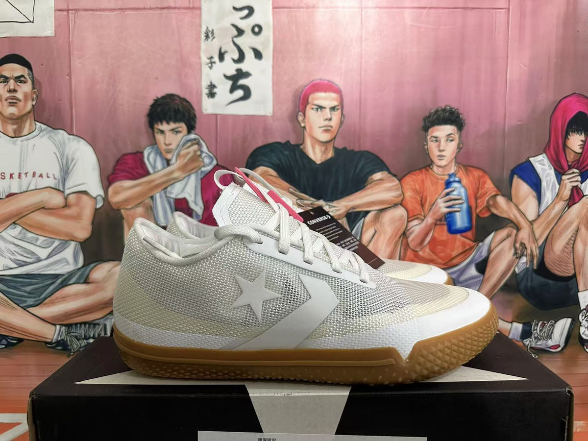 Side view showing the star-and-chevron detail on white Converse sneakers