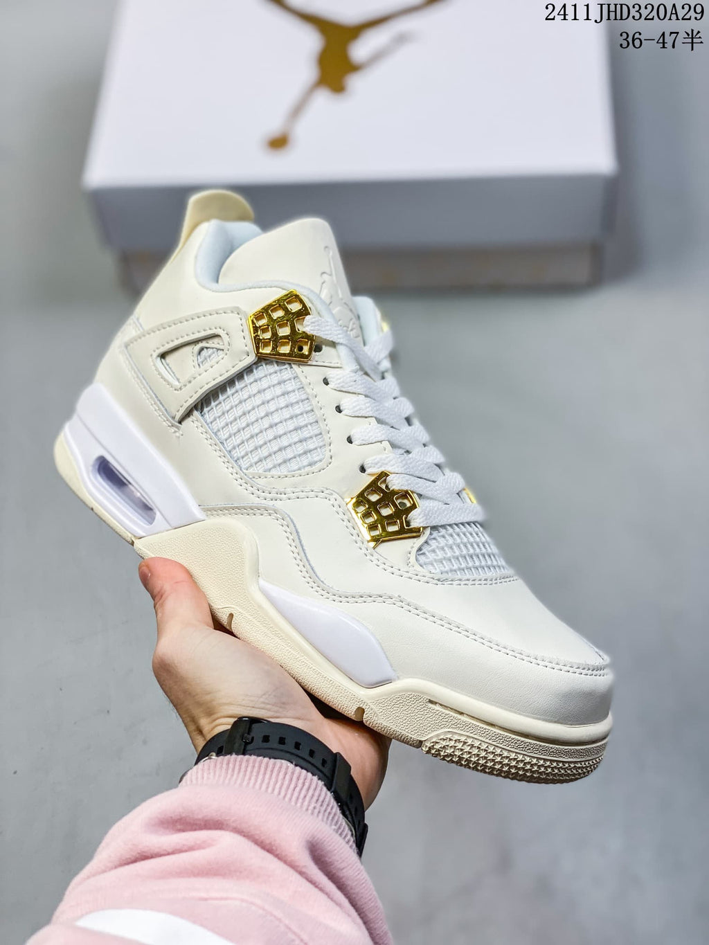 Close-up of an off-white sneaker with gold-tone lace wings, mesh panels, a visible cushioning unit, and a textured outsole.