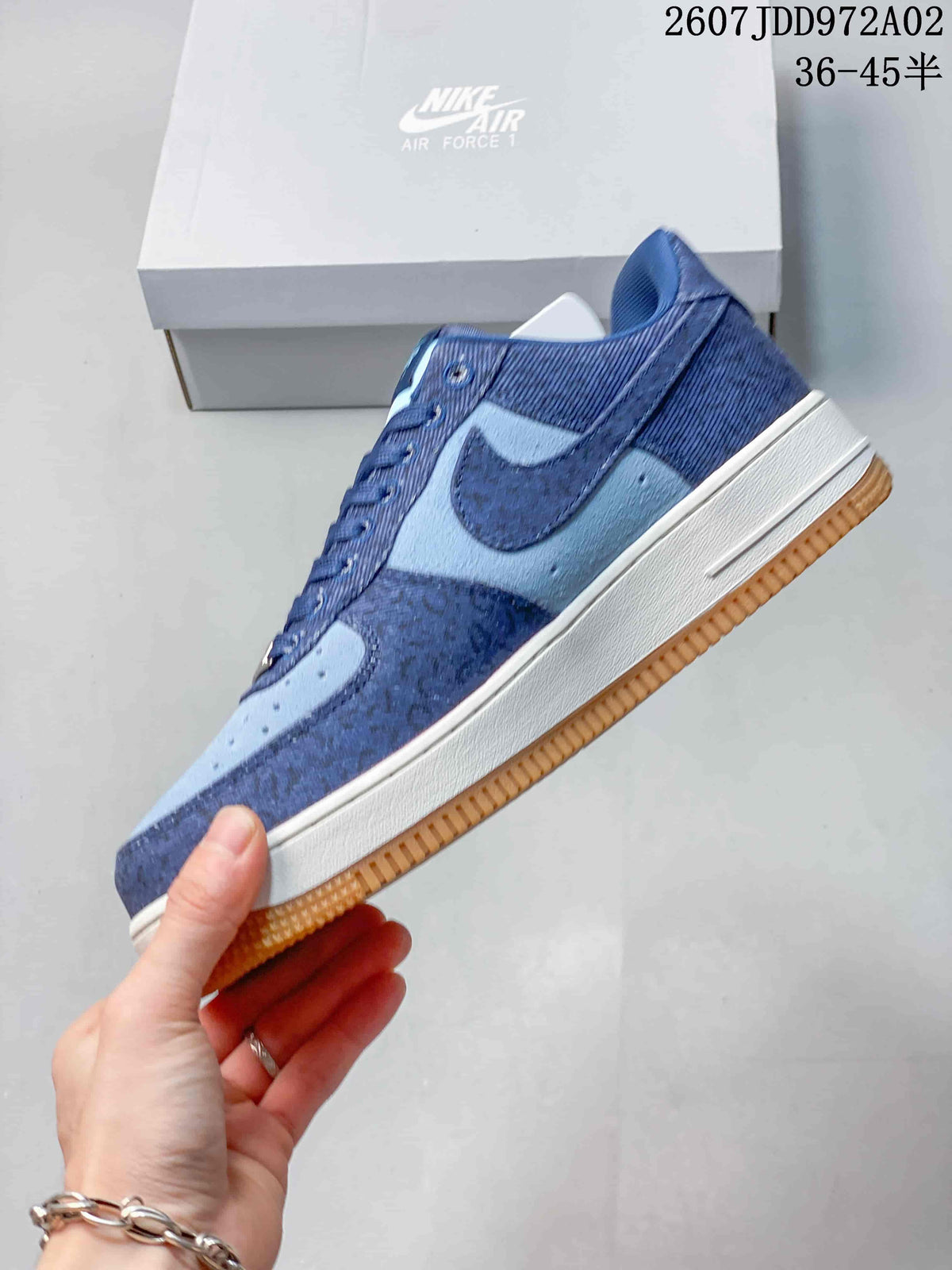 Side view of the blue Nike Air Force 1 sneaker with a gum outsole