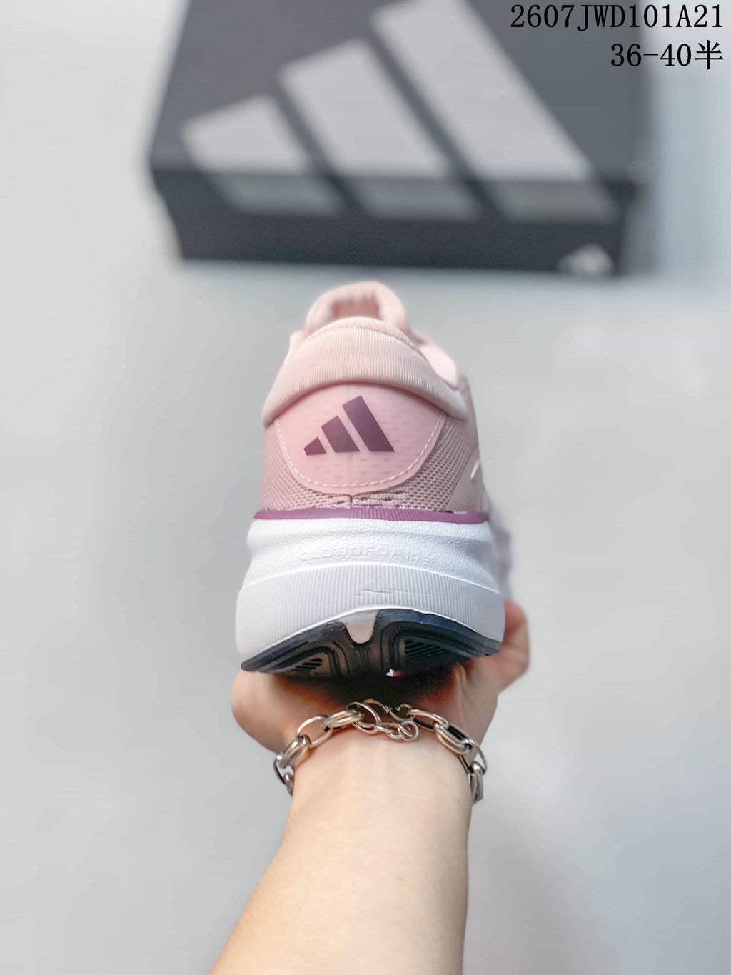 Rear view of the pink sneaker showing the padded heel, Adidas logo and white midsole.