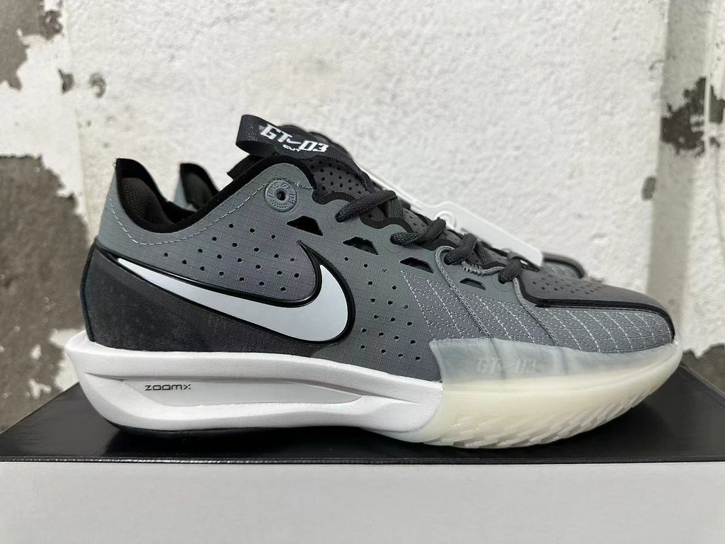 Side view of a grey and black shoe with a contrasting Swoosh, crosshatched detailing, and visible GT-03 and ZOOMX markings.