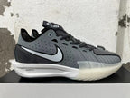 Side view of a grey and black shoe with a contrasting Swoosh, crosshatched detailing, and visible GT-03 and ZOOMX markings.