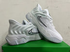 Pair of white and grey Nike sneakers showing the side logo and sculpted soles