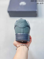 Rear view of the gray-green sneaker showing the Nike Air heel branding and layered outsole.