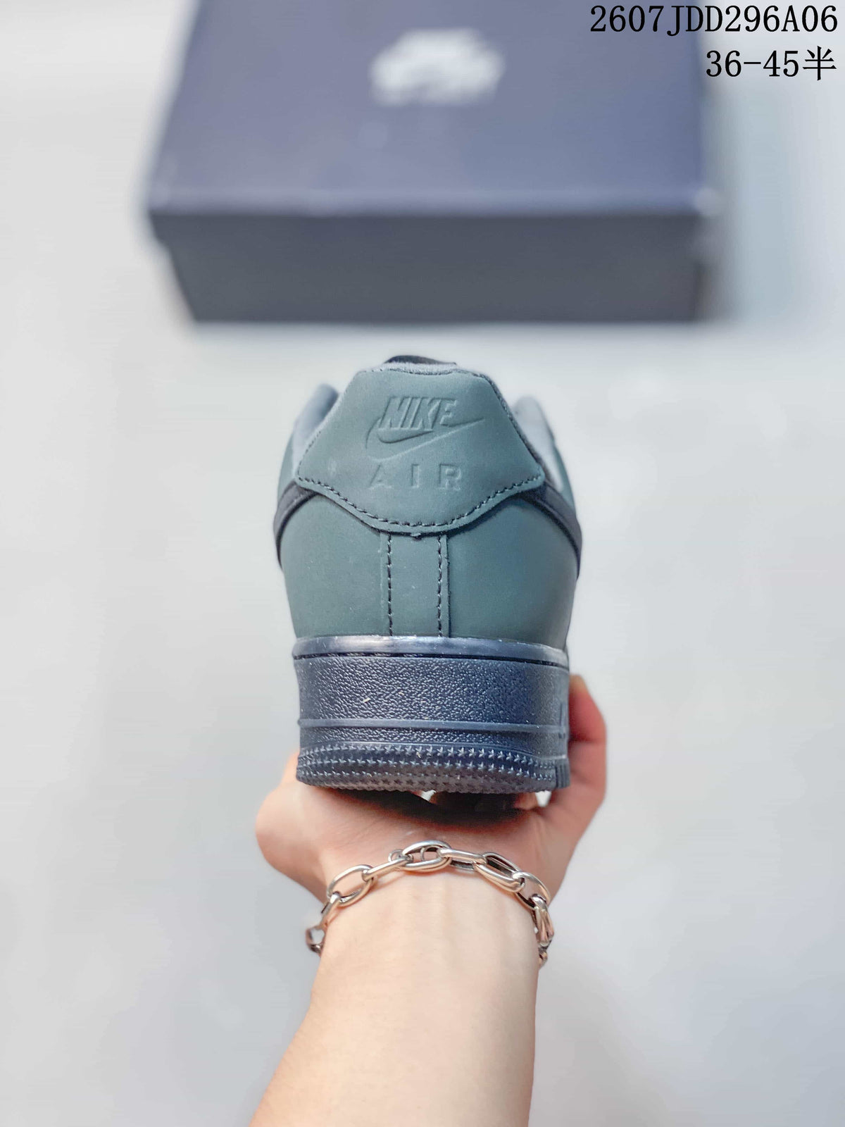 Rear view of the gray-green sneaker showing the Nike Air heel branding and layered outsole.