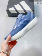 Side view of the blue running shoe with three-stripe details and white sole