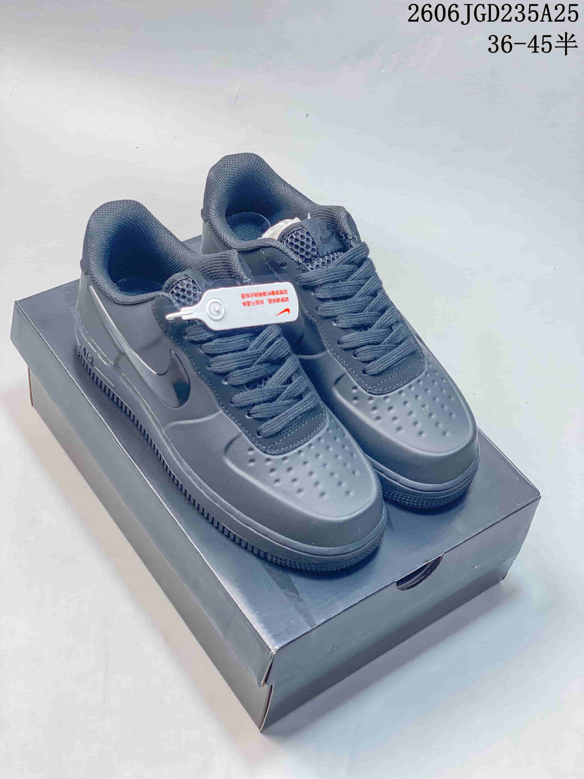 Pair of dark Nike Air Force 1 low-top sneakers displayed on a shoebox, with a visible product code and size range overlay.