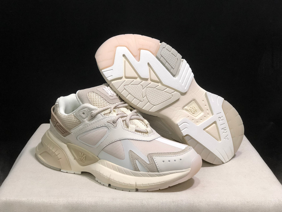 AMIRI MA Runner sneakers shown from an angled front view, including the patterned outsole of one shoe.