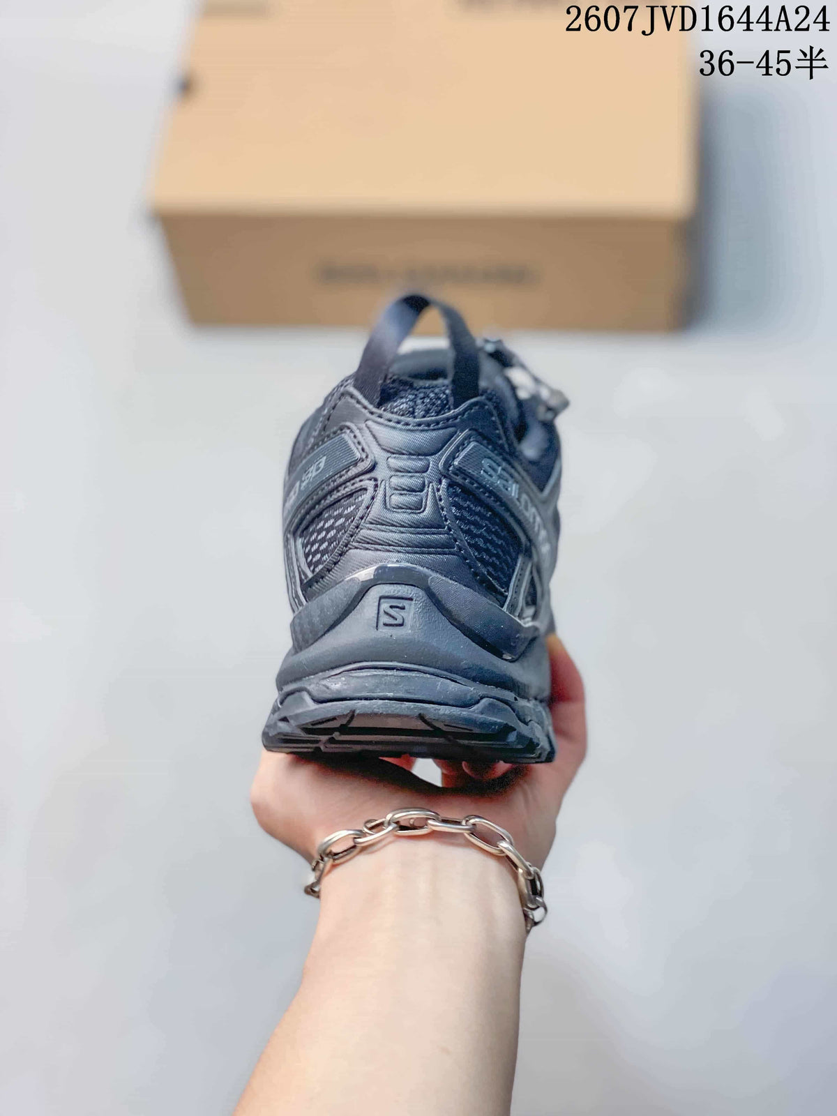 Rear view of the black Salomon sneaker showing the heel structure, pull tab and outsole.