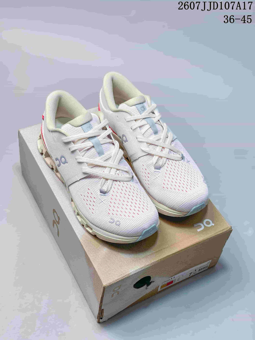 Pair of white On Cloud X 4 AD sneakers displayed on a shoebox, with light blue outsole details and red accents; source text shows style code 2607JJD107A17 and size range 36-45.