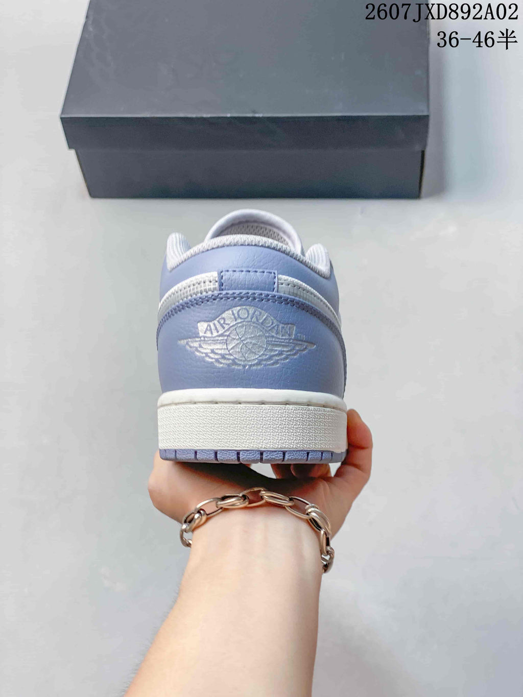 Rear view showing the blue-gray heel panel and embossed Jordan branding.