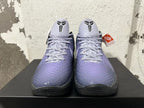 Front view of purple Nike Kobe basketball shoes showing textured uppers, laces, and Kobe logos.
