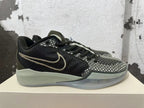 Side view of a black basketball shoe with a contrasting Swoosh and patterned forefoot