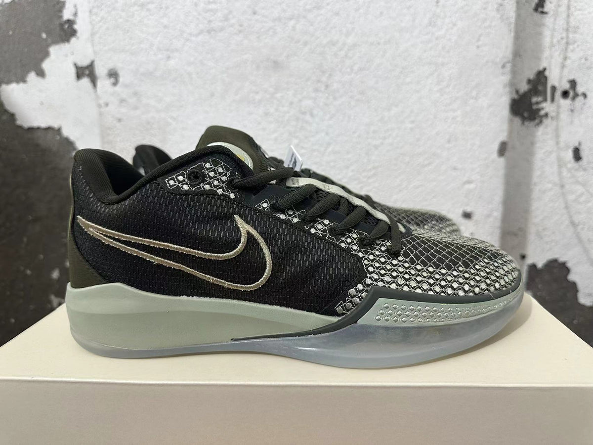 Side view of a black basketball shoe with a contrasting Swoosh and patterned forefoot