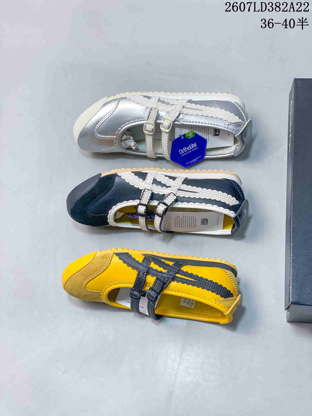 Top-down view showing the silver and white, navy and white, and yellow and black colorways.