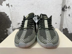 Front view showing a geometric patterned forefoot, dark laces, and light-colored sole