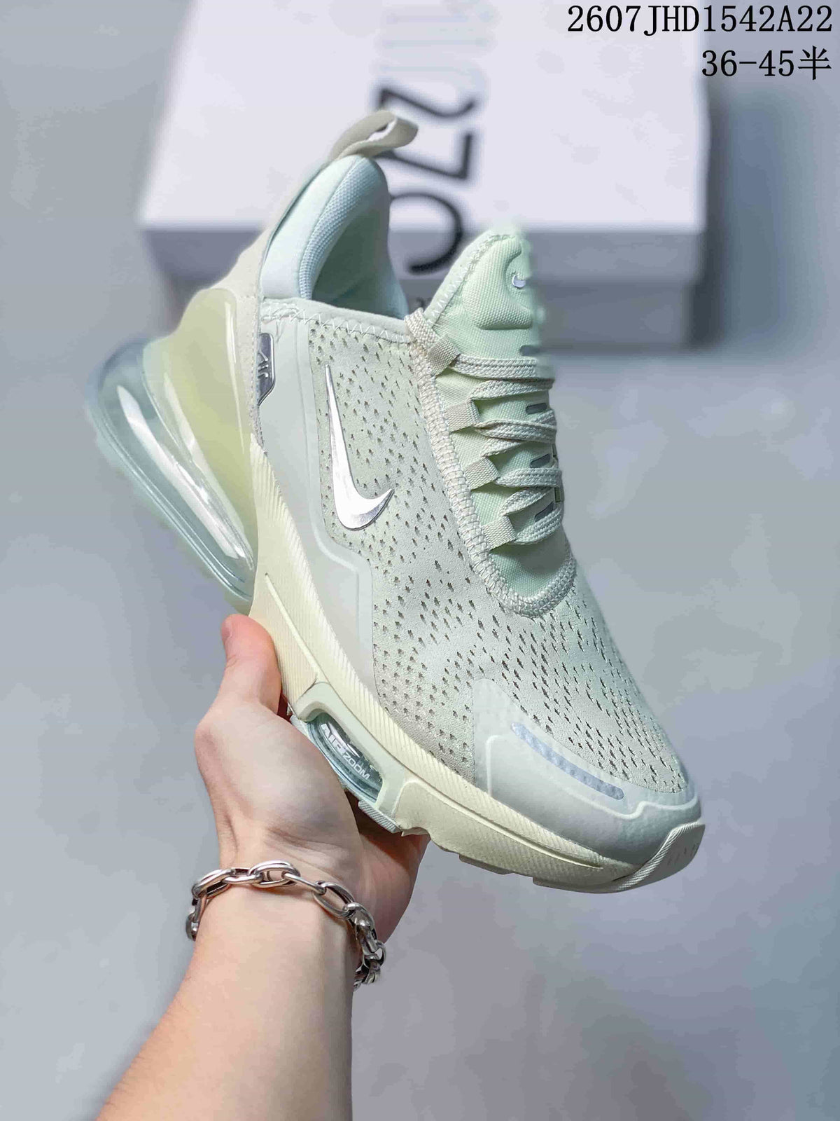 Angled side view showing the perforated upper, Swoosh logo, and large transparent heel unit.
