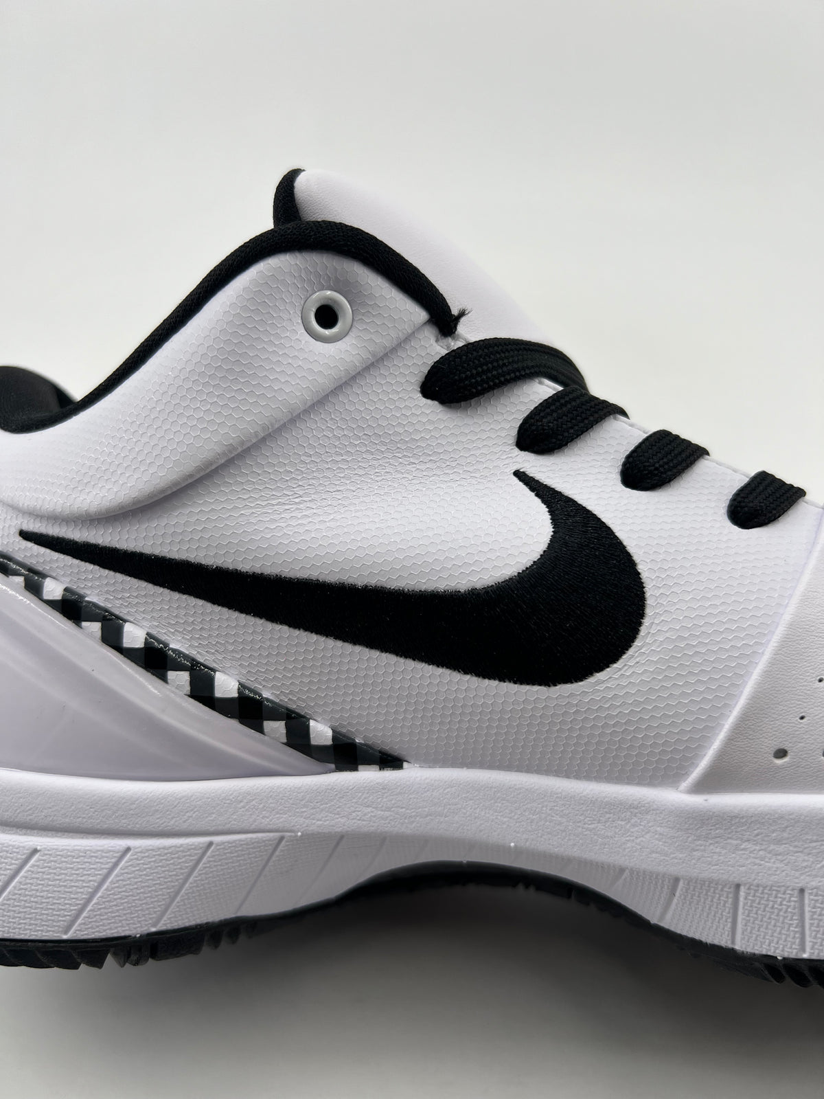 Close-up of the black Swoosh and textured white side panel