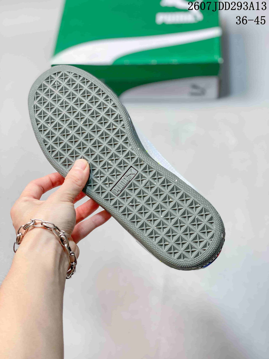 Close view of the gray geometric tread pattern on the outsole of a PUMA sneaker.