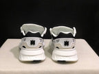 Rear view of the sneakers showing AMIRI branding, heel details and white midsoles.