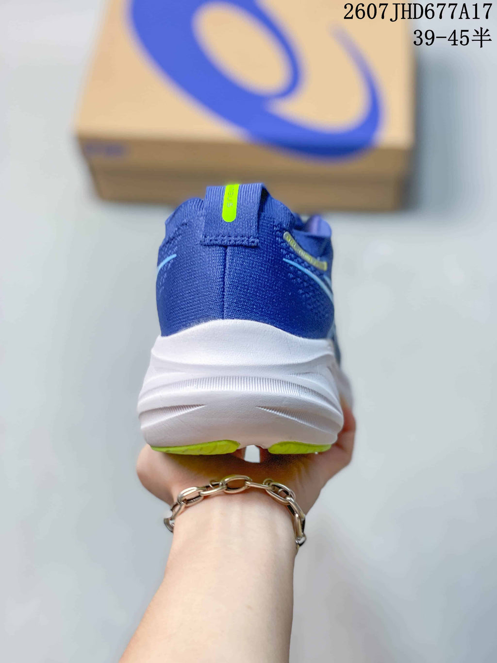 Rear view showing the blue heel counter, padded collar and white sculpted midsole.