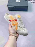 White and cream Onitsuka Tiger Mexico 66 Sabot slip-on sneaker with orange and red contrasting stripes.