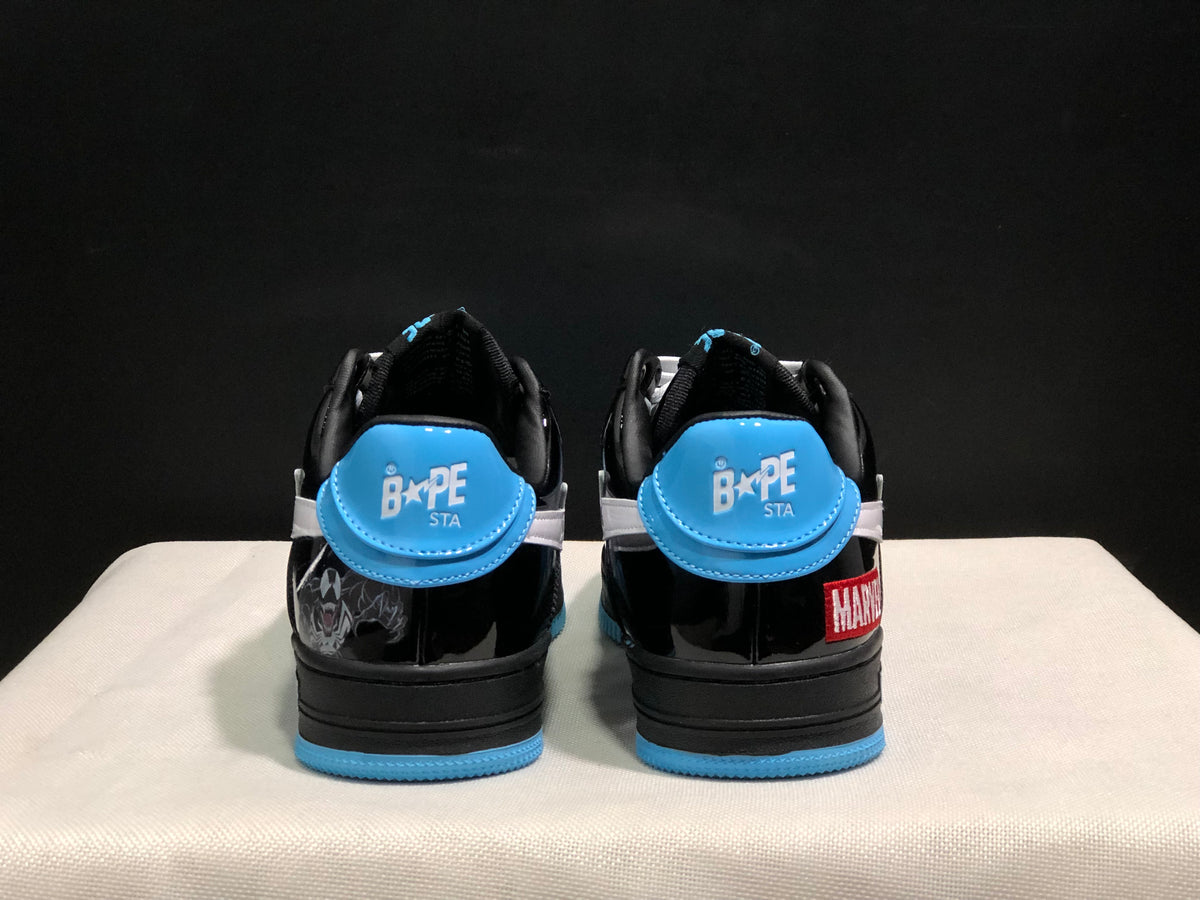 Rear view of the pair showing blue heel panels, BAPE STA markings, black uppers, and Marvel details.