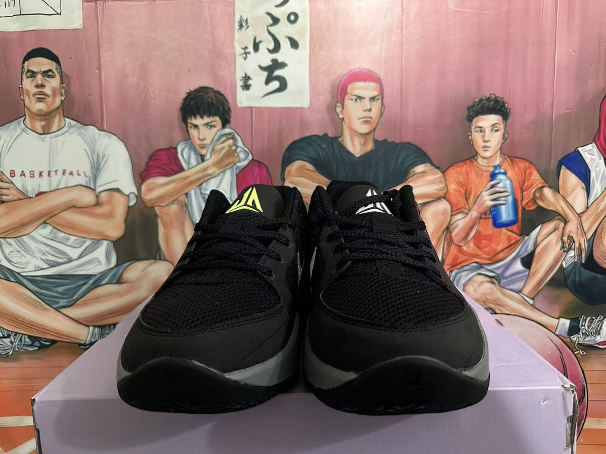 Front view of black Nike sneakers with textured forefoot panels, black laces, and contrasting gray midsoles.