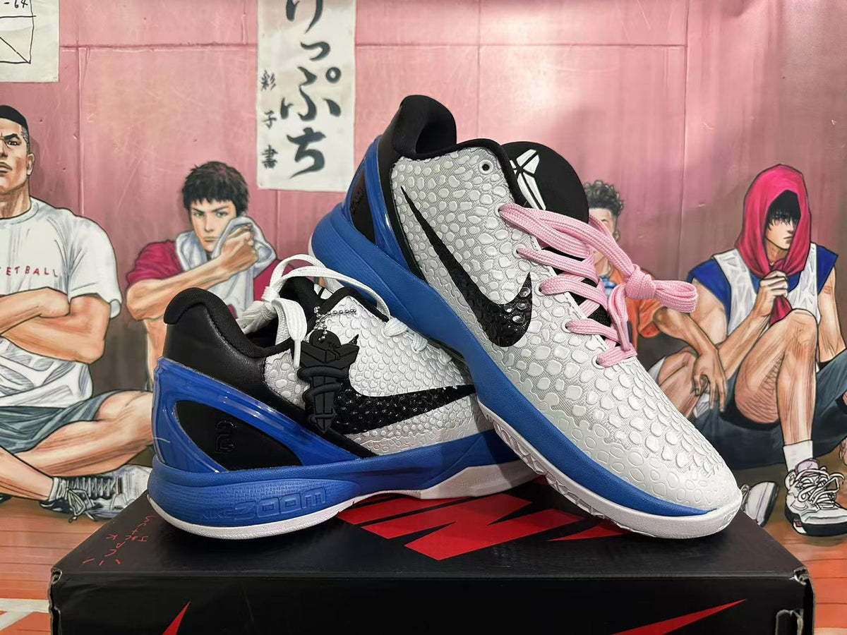Angled view of the pair showing the black and blue heel sections, textured white uppers, and contrasting laces.