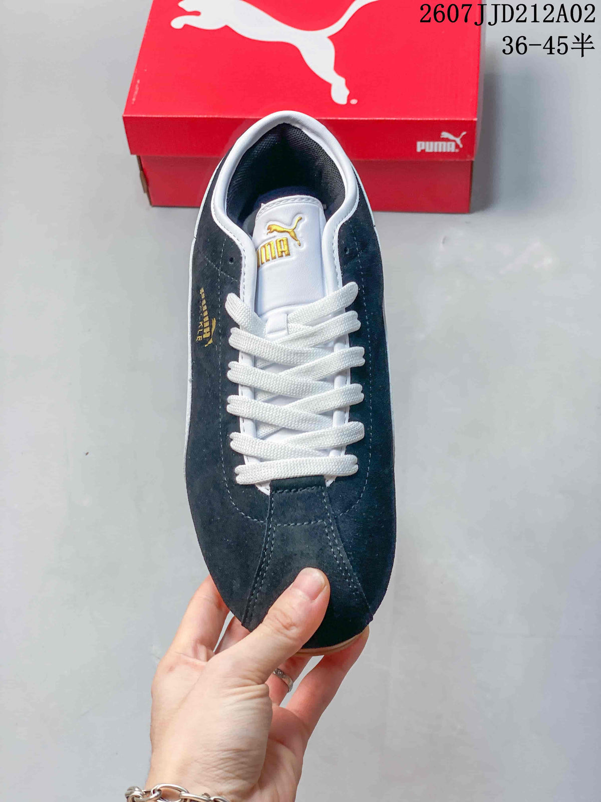 Top view of the navy PUMA Tackle sneaker showing white laces and tongue branding