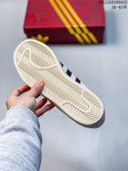 Underside of the sneaker showing a cream-colored rubber outsole with a zigzag traction pattern.