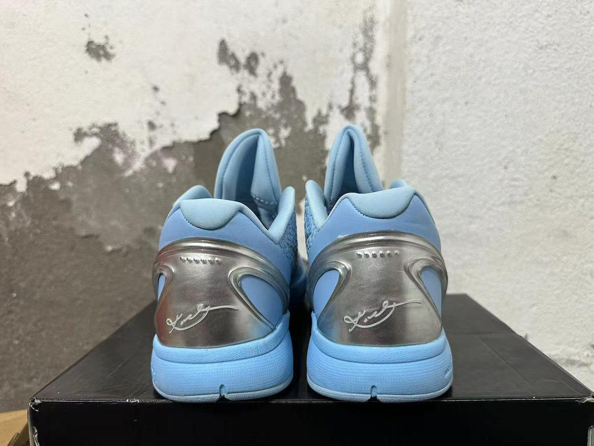 Rear view of light blue Nike basketball shoes showing silver-tone heel panels and signature-style detailing.