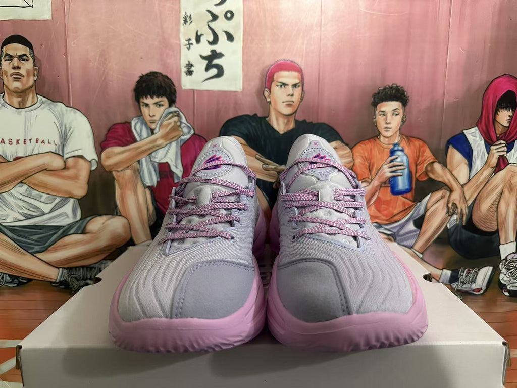 Front view of gray and pink Kyrie basketball shoes with pink laces.