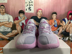 Front view of gray and pink Kyrie basketball shoes with pink laces.